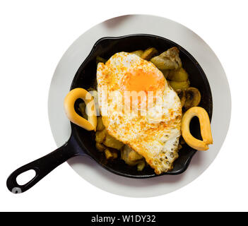 Premium Photo  Scrambled, frying eggs from one egg in a small pan on  yellow background