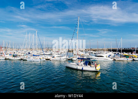 Morgat, France - August 4, 2018:  The marina of Morgat a sunny day of summer with many smalls boats aligned in the piers Stock Photo