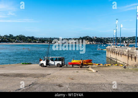 Morgat, France - August 4, 2018:  People taking out the water and storing canoes and kayaks in the marina of Morgat a sunny day of summer Stock Photo