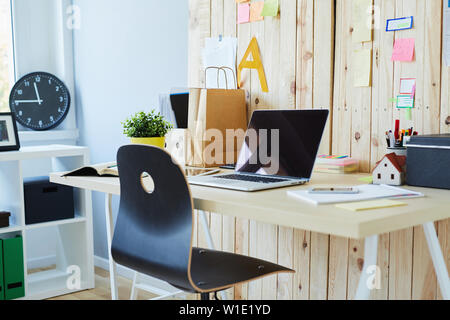 Modern workspace - photo of a desk with open laptop in creative office Stock Photo