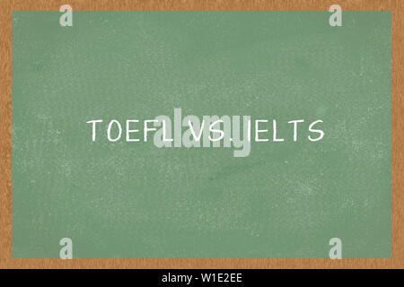 Word TOEFL vs. IELTS , Green Chalkboard background. Test of English as a Foreign Language exams Stock Photo