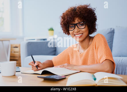 Happy woman studying from home, preparing for exam Stock Photo