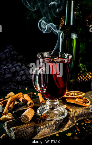 Hot autumn winter drink. Grog, warm tea with spices and dried oranges Stock Photo