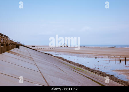 Heavy machinery on the beach by the new flood defences and sloping concrete revetment on the Lancashire Fylde coast at Cleveleys Stock Photo