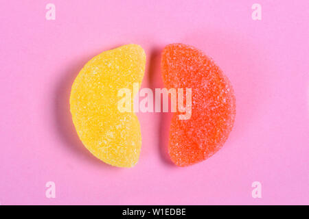 orange and lemon jelly candy on pink background Stock Photo