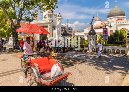 A local rickshaw (tuk tuk) outside Kapitan Keling Mosque, in George Town, Penang Island, Malaysia, Southeast Asia, Asia Stock Photo