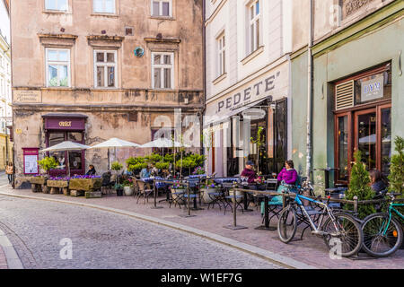 A cafe scene in the medieval old town, UNESCO World Heritage Site, in Krakow, Poland, Europe Stock Photo