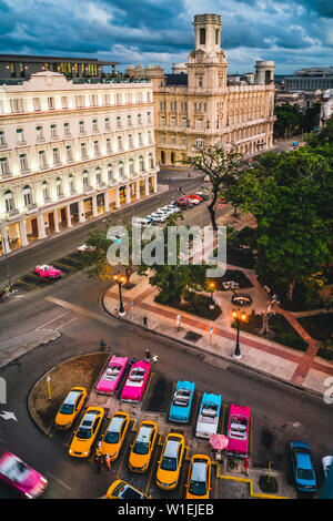 Aerial view colourful old American taxi cars parked in Havana at dusk, La Habana, Cuba, West Indies, Caribbean, Central America Stock Photo