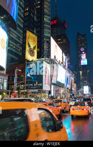 Yellow taxis in Times Square at night. New York City, New York, United States of America, North America Stock Photo