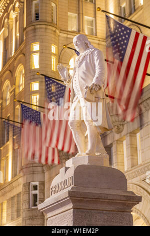 View of Benjamin Franklin statue and US flags in front of former Old Post Office Pavilion, Washington D.C., United States of America, North America Stock Photo