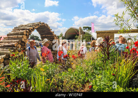 Hampton Court  London, UK. 2nd July 2019.  Visitors attend the showgardens  at the  RHS Hampton Court garden  festival. Credit: amer ghazzal/Alamy Live Stock Photo