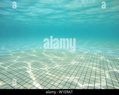 underwater view of swimming pool floor with sunlight reflections. concept of leisure activities and summer Stock Photo