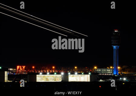 Atlanta, GA / USA : 27. May, 2015 - nightime view of the Atlanta international airport with air traffic control and streaks of planes taking off over