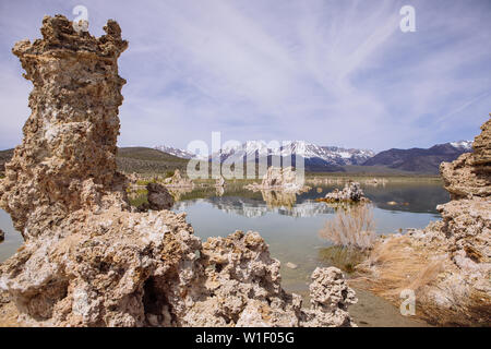 Tufas in Mono Lake with snowed mountains at the back, Calcium-Carbonate Spires and Knobs, Lee Vining, California, USA Stock Photo