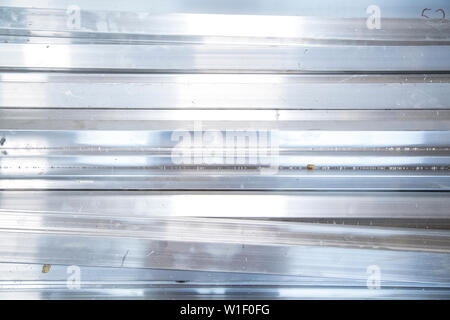 Shiny metal pieces reflecting indoor light Stock Photo