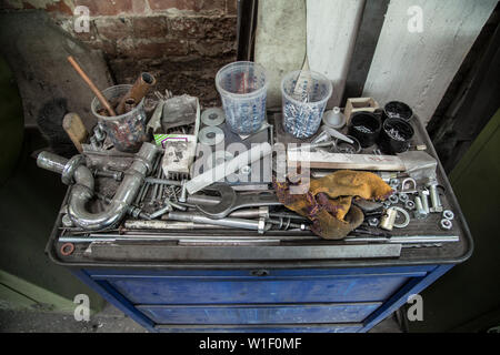 Toolbox with various instruments and parts lying on top. High angle view. Stock Photo