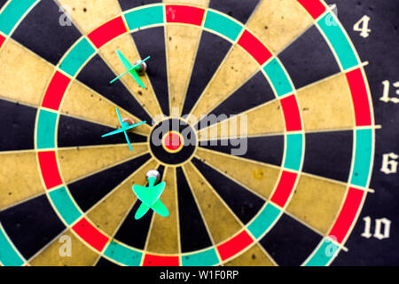 Close-up Three darts in side the target on aged dartboard Stock Photo
