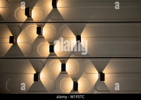 Vertical Lamp settle on the horizontal wall with Tungsten light beside it. Stock Photo