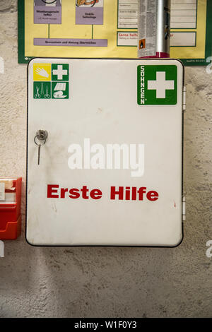 First aid kit on factory wall Stock Photo