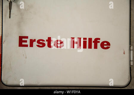 First aid kit on factory wall Stock Photo