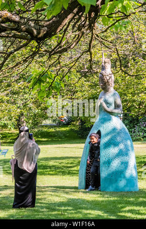 Regents Park, London, UK. 2nd July 2019. A family enjoy the work by Leiko Ikemura, Usagi Kannon II (2013-2018), Presented by Kewenig - Frieze Sculpture, one of the largest outdoor exhibitions in London, including work by 25 international artists from across five continents in Regent’s Park from 4th July - 7th October 2019. Credit: Guy Bell/Alamy Live News Stock Photo