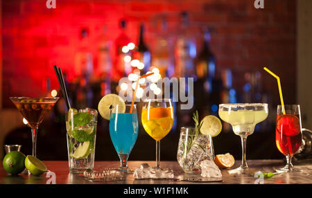 Set with different cocktails on a bar lights background. Stock Photo