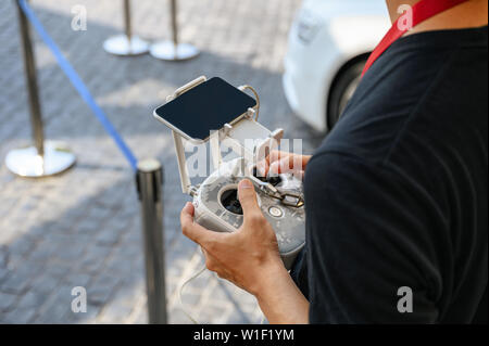 Professional videographer holding remote control for UAV drone Stock Photo