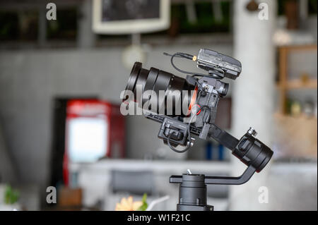 Mirrorless camera with mic wireless on gimbal stabilizer for filming Stock Photo