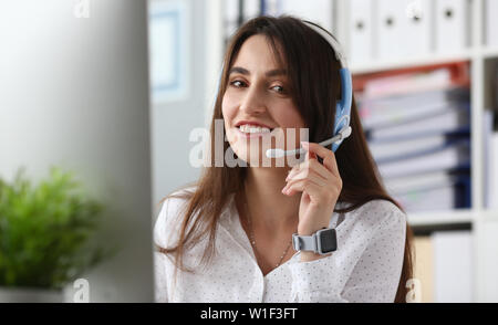 Young beautiful female employee of the call center Stock Photo