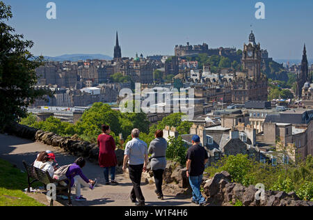 Tourists looking over Edinburgh city centre towards the castle from Calton Hill, Scotland, UK Stock Photo