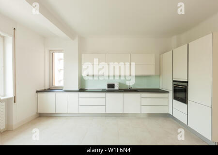 Wide white kitchen in a modern apartment Stock Photo