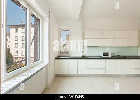 Wide white kitchen in a modern apartment Stock Photo