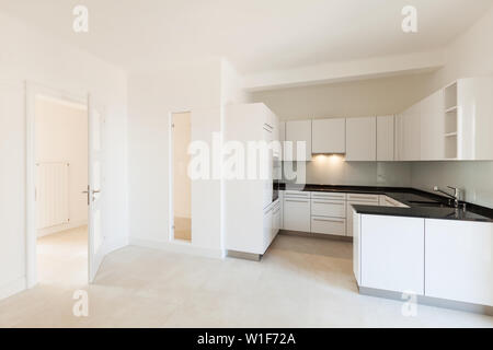 Wide white kitchen in a modern apartment Stock Photo