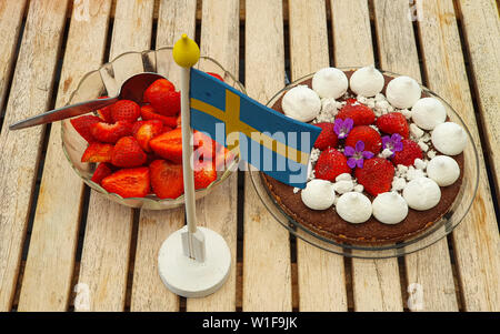 Delicious strawberry cake on wooden background. Swedish midsummer celebration. Stock Photo