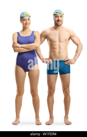 Full length portrait of a young man and woman in swimming suits, googles and a cap isolated on white background Stock Photo