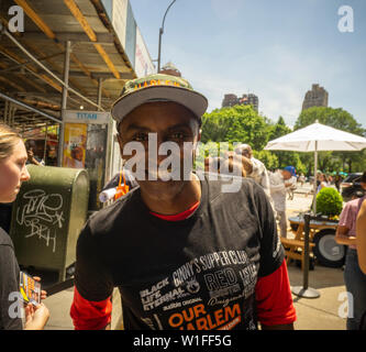Celebrity Chef Marcus Samuelsson greets visitors to the Audible food truck serving samples of his dishes in Union Square in New York on Thursday, June 27, 2019. Samuelsson voices Audible’s audiobook adaptation, “Our Harlem”, of his Red Rooster Cookbook adding interviews. (© Richard B. Levine) Stock Photo