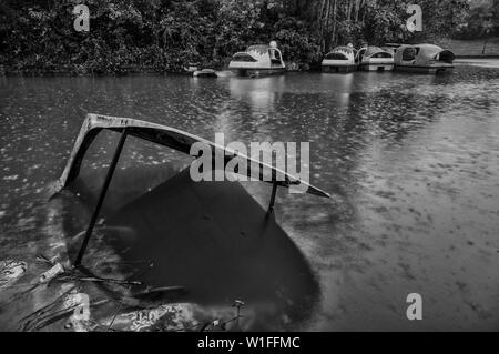 rowboat transportationsystem rain calamity canoe Stock Photo