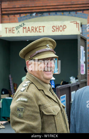 Kidderminster, UK. 29th June, 2019. Severn Valley Railways 'Step back to the 1940's' gets off to a fabulous start this weekend with costumed re-enactors playing their part in providing an authentic recreation of wartime Britain. An Arthur Lowe lookalike stands on duty at a vintage train station as WW2 platoon commander, Captain Mainwaring, in his Home Guard uniform. Credit: Lee Hudson Stock Photo