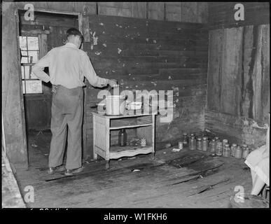 Jo King, miner and widower, who lives in this house for which he pays $3 monthly with his three children. Cary, Bell County, Kentucky. Stock Photo