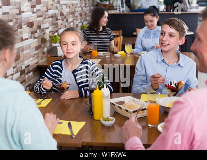Glad family having lunch in cozy cafe Stock Photo