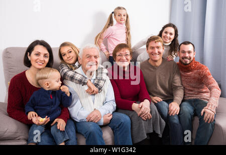 Grandparents 60-70 years old with children are photographing best moments during Christmas dinner. Stock Photo