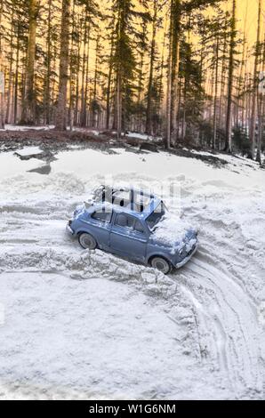 Diorama - Vintage car on snow-covered mountain road Stock Photo