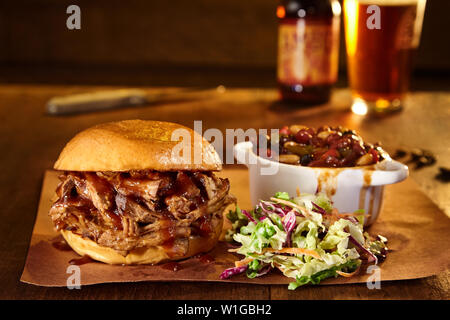 BBQ Pulled Pork Sandwich with baked beans and slaw Stock Photo