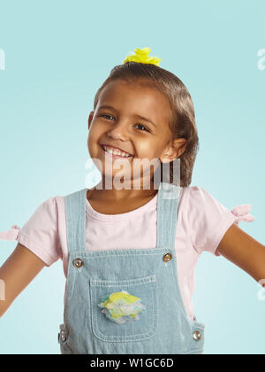mix-raced little girl in overalls Stock Photo