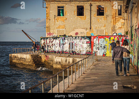 A couple walking in the 'Cais do Ginjal', Lisbon, Portugal Stock Photo