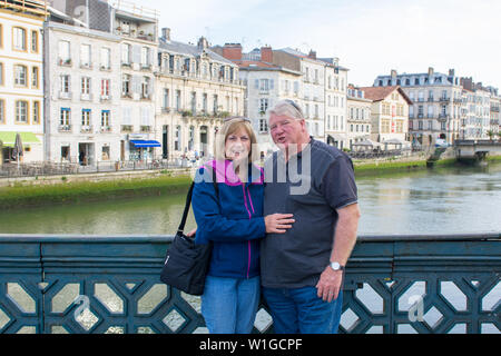 Senior couple traveling around Europe enjoying retirement lifestyle and freedom. In healthy active old people and Europe landmarks and Tourism concept Stock Photo