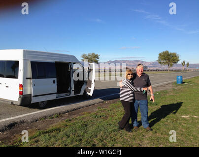 Happy beautiful senior couple in love traveling in a campervan around Europe in Retirement lifestyle, traveling and healthy active elderly people. Stock Photo