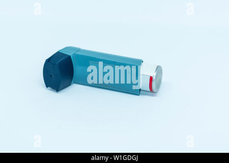 One inhaler laying on its side facing away from the camera with a white ...
