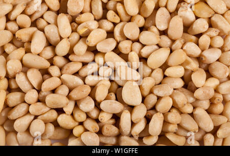 Close up of pine nuts scattered on wooden surface Stock Photo