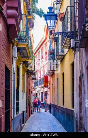 Narroiw streets or alleys in the Barrio de Santa Cruz or old Jewish Quarter of Seville Spain Stock Photo